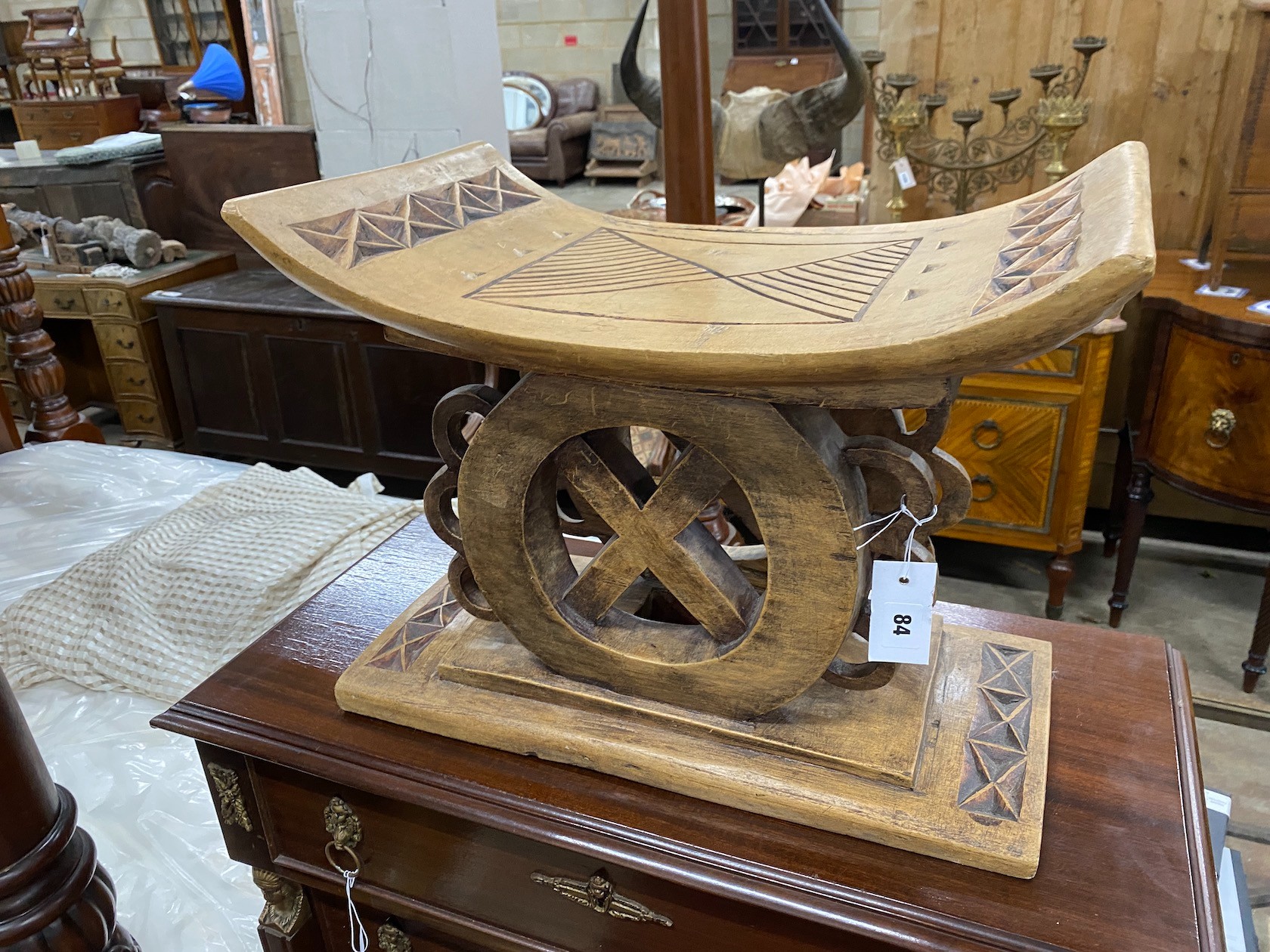 An African carved hardwood stool, width 49cm, depth 27cm, height 38cm